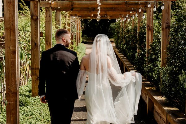angel hotel wedding venue in hampshire couple walking in garden
