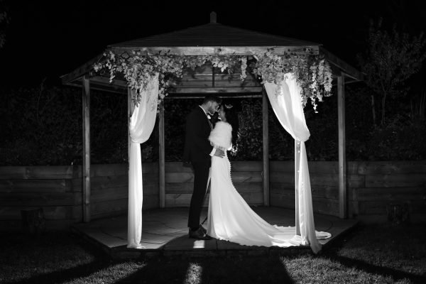 angel hotel wedding venue in hampshire couple kissing under pergola